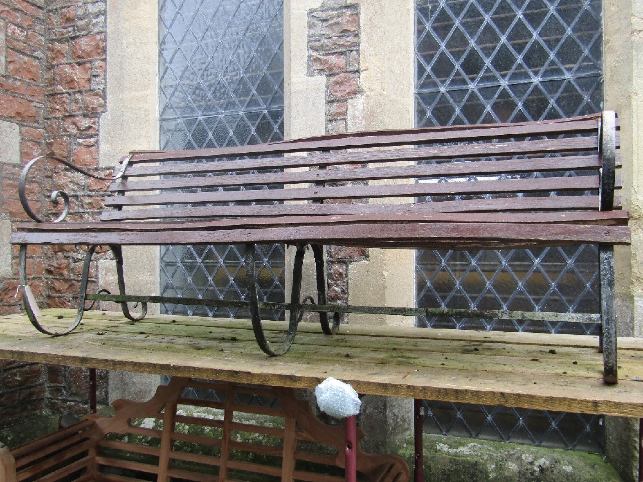 Appraisal: A sprung steel park bench with stained wooden slatted seat