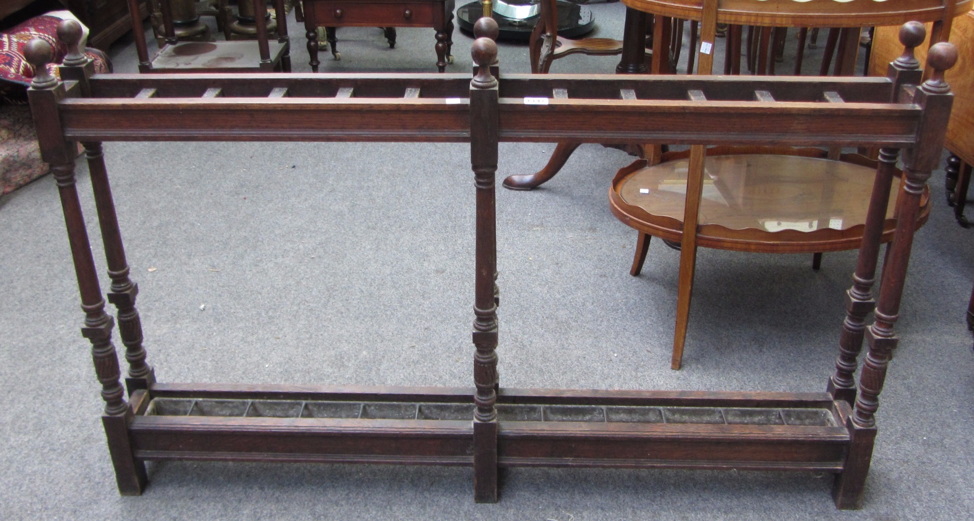 Appraisal: A th century oak narrow twelve division umbrella stick stand