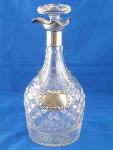 Appraisal: A cut glass decanter silver mounted with a three way