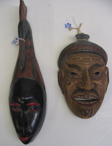 Appraisal: TWO HAND CARVED FACE MASKS the first African from Ivory