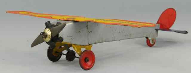 Appraisal: GIRARD TIN MONOPLANE Silver fuselage lithographed tin wing reads ''Transcontinental''