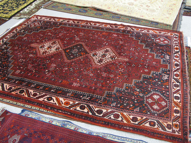 Appraisal: PERSIAN SHIRAZ CARPET three geometric medallion and overall stylized floral