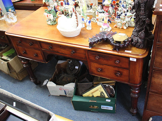 Appraisal: A VICTORIAN MAHOGANY KNEE HOLE WRITING TABLE with galleried back