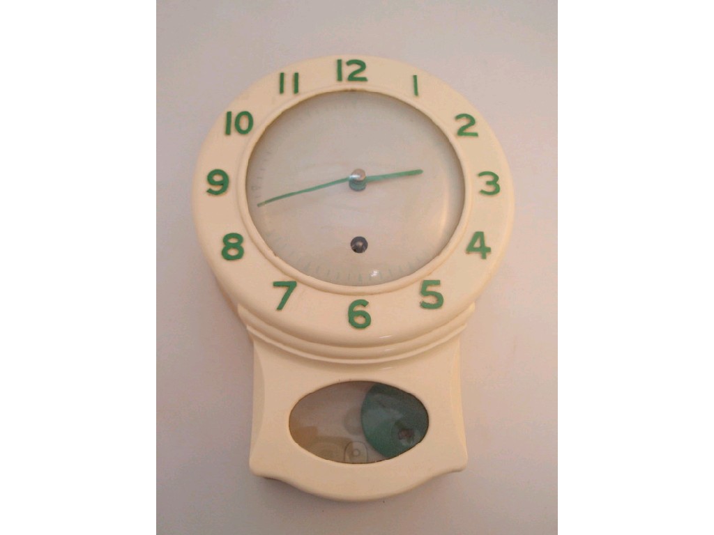 Appraisal: A mid thC Bakelite kitchen clock with green hands baton