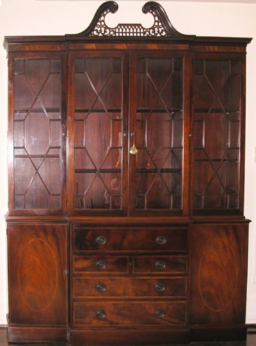 Appraisal: Artist Title Mahogany breakfront cabinet arched fretted and dentil molded