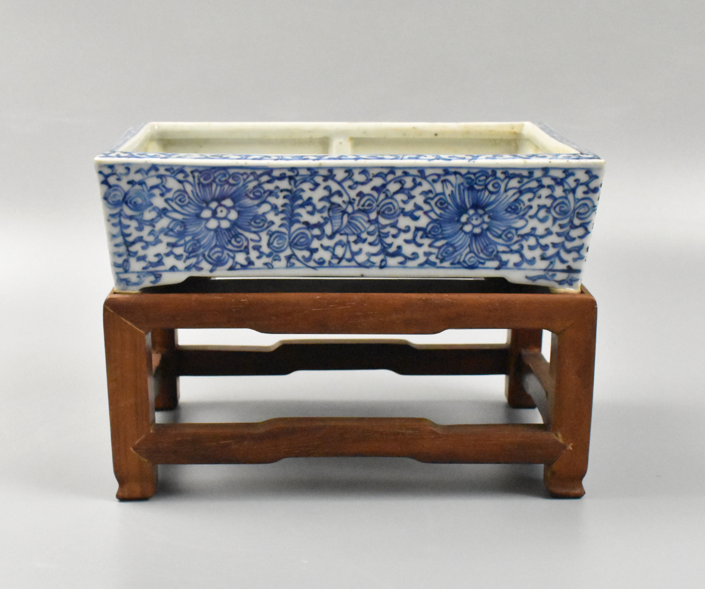 Appraisal: A Chinese blue and white rectangular planter with wooden stand