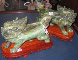 Appraisal: PAIR OF CHINESE CARVED GREEN JADEITE SCULPTURES of stylized foo