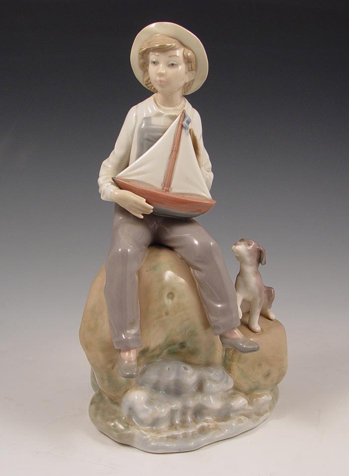 Appraisal: LLADRO PORCELAIN SEA FEVER BOY WITH TOY SAILBOAT Retired in