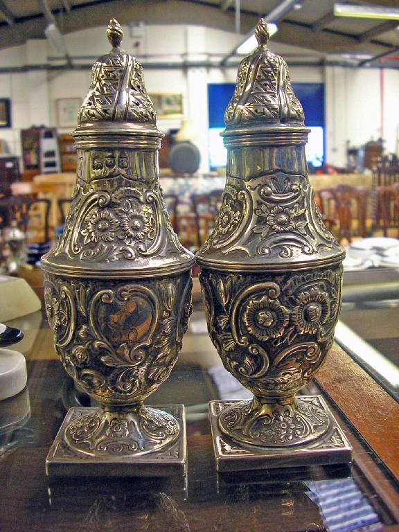 Appraisal: A pair of silver peppers of baluster form with all