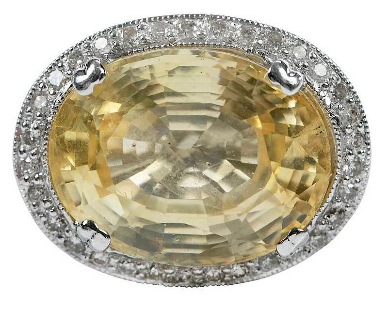 Appraisal: kt Sapphire and Diamond Ring center oval faceted yellow sapphire