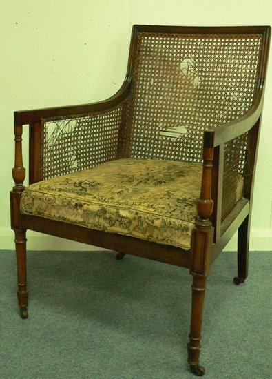 Appraisal: A library armchair of Bergere design with cane back sides