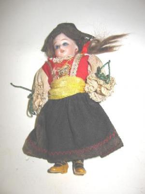 Appraisal: A German bisque head dolls house doll with blue glass