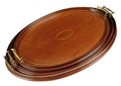 Appraisal: A Edwardian graduated set of three mahogany oval galleried trays