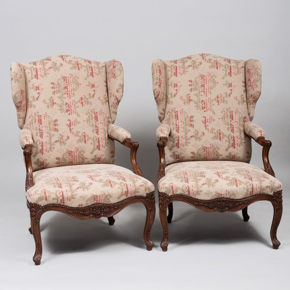 Appraisal: Pair of R gence Style Carved Beechwood Wing Chairs x