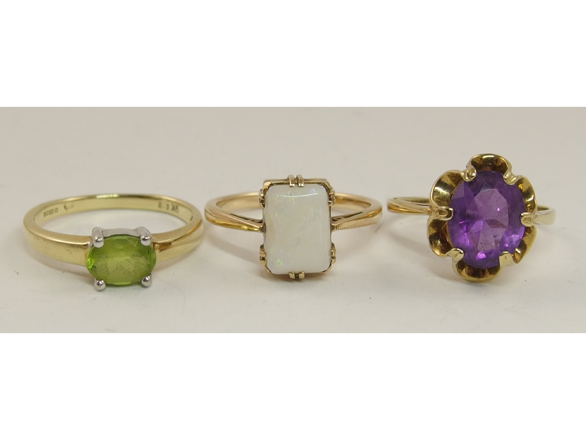 Appraisal: Three ct gem set rings to include peridot amethyst and