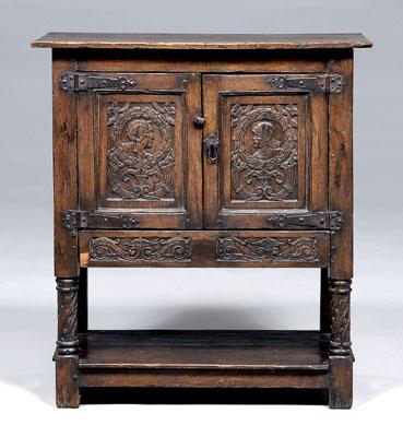 Appraisal: Baroque style carved oak cabinet two doors with iron strap