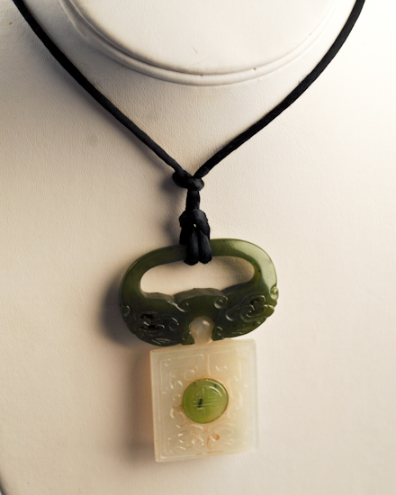 Appraisal: A Chinese Two Color Jade Pendant on a silk cord