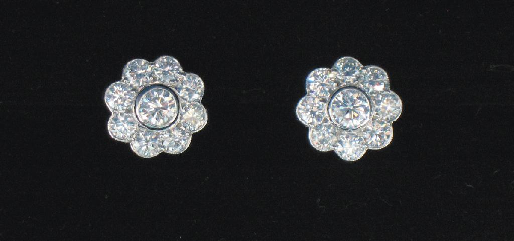 Appraisal: A PAIR OF DIAMOND-SET CLUSTER EAR STUDS of flowerhead design