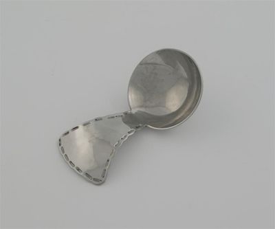 Appraisal: An arts and crafts chromium plated caddy spoon by Keswick