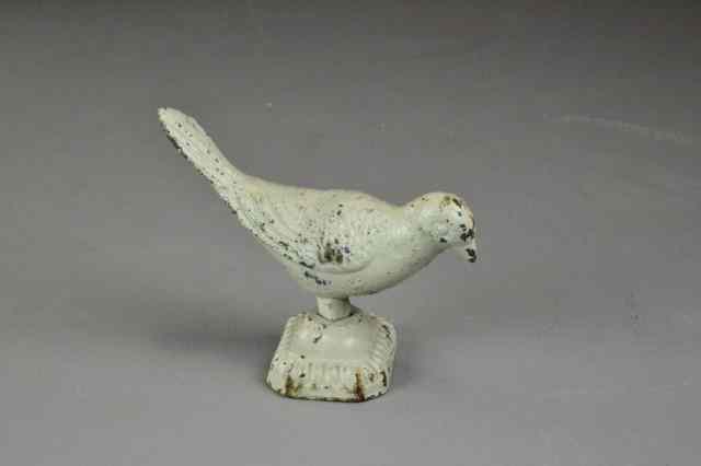 Appraisal: CAST IRON BIRD PAPERWEIGHTWhite painted cast iron standing bird on