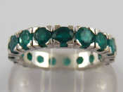 Appraisal: A white metal tests carat gold emerald eternity ring the