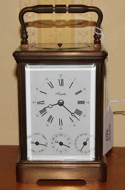 Appraisal: A BRASS CARRIAGE CLOCK the enamel dial with Roman numerals