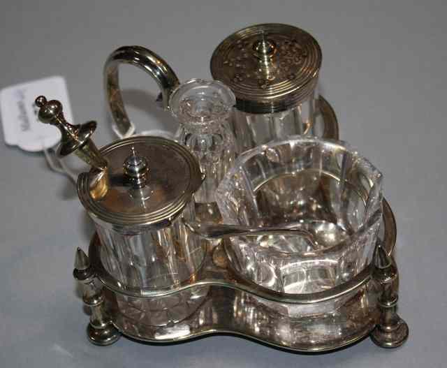 Appraisal: A SET OF FOUR SILVER PLATED CRUETS with three bottles