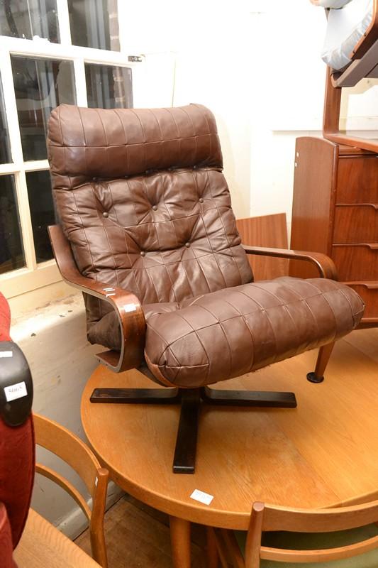 Appraisal: A DANISH STYLE LEATHER UPHOLSTERED ARMCHAIR A DANISH STYLE LEATHER