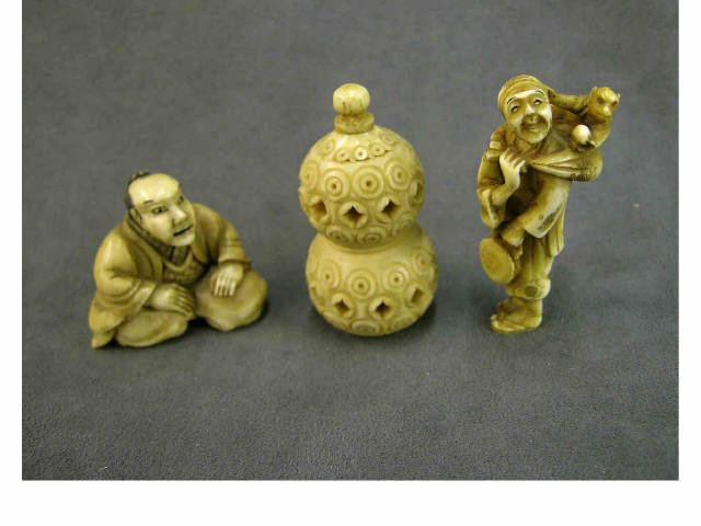 Appraisal: Three stained ivory netsuke including standing man carrying satchel with