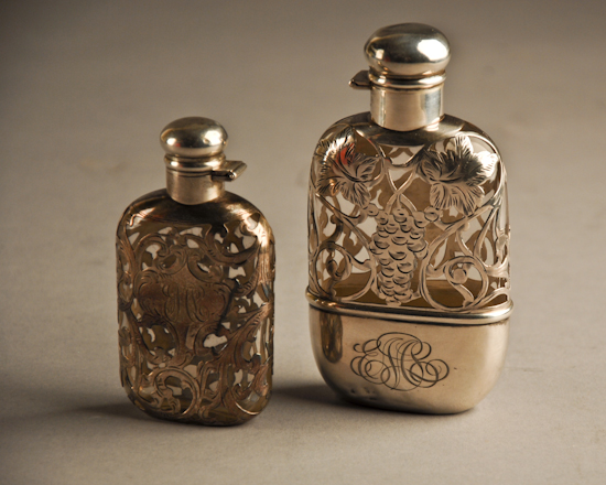 Appraisal: Two Silver Overlay Flasks the smaller having unmarked silver monogrammed