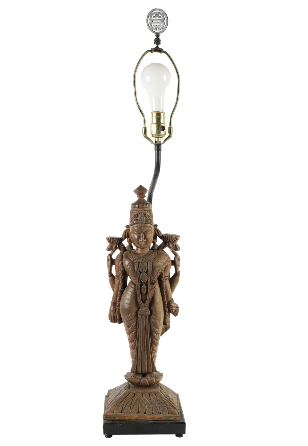 Appraisal: EAST-ASIAN CARVED WOOD FIGUREmounted as a table lamp inches wide