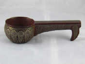 Appraisal: A carved Russian hardwood kovsch with fine inlaid white metal