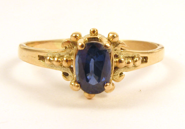 Appraisal: SAPPHIRE AND FOURTEEN KARAT GOLD RING centering an oval-cut blue