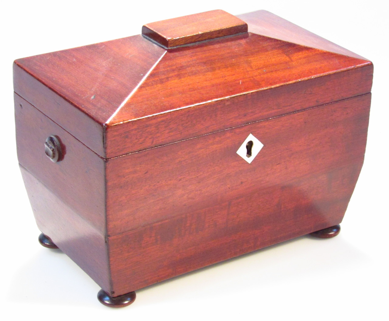 Appraisal: A Regency mahogany tea caddy the sarcophagus shaped top hinging