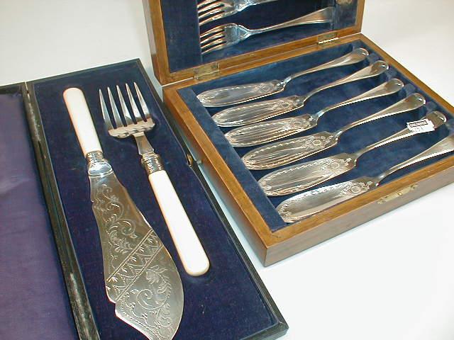 Appraisal: A cased pair of electroplate fish servers with ivorine handles