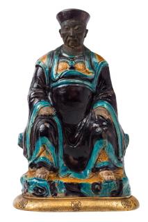 Appraisal: A TURQUOISE AUBERGINE AND MUSTARD-YELLOW GLAZED FIGURE OF CAI SHEN