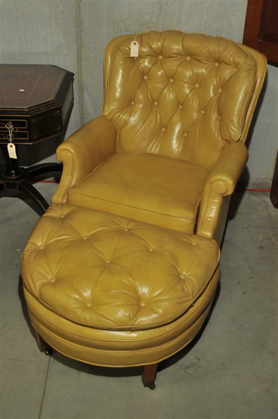 Appraisal: LEATHER ARMCHAIR AND OTTOMAN Mustard yellow button back armchair with