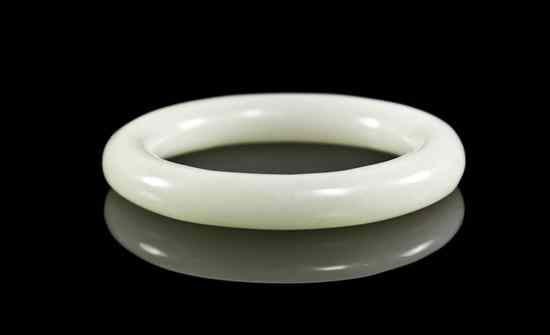 Appraisal: A White Jade Bangle of circular form the interior of