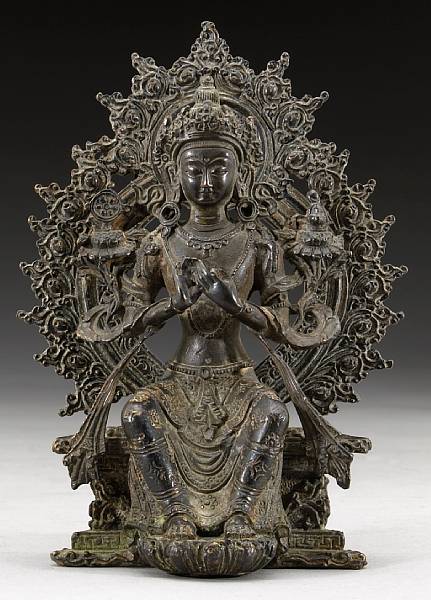 Appraisal: A Himalayan patinated bronze figure of a Maitreya The crowned