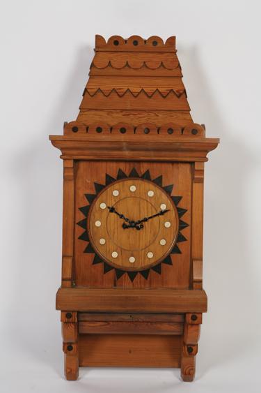 Appraisal: A PITCH PINE AND EBONY GOTHIC REVIVAL WALL CLOCK in