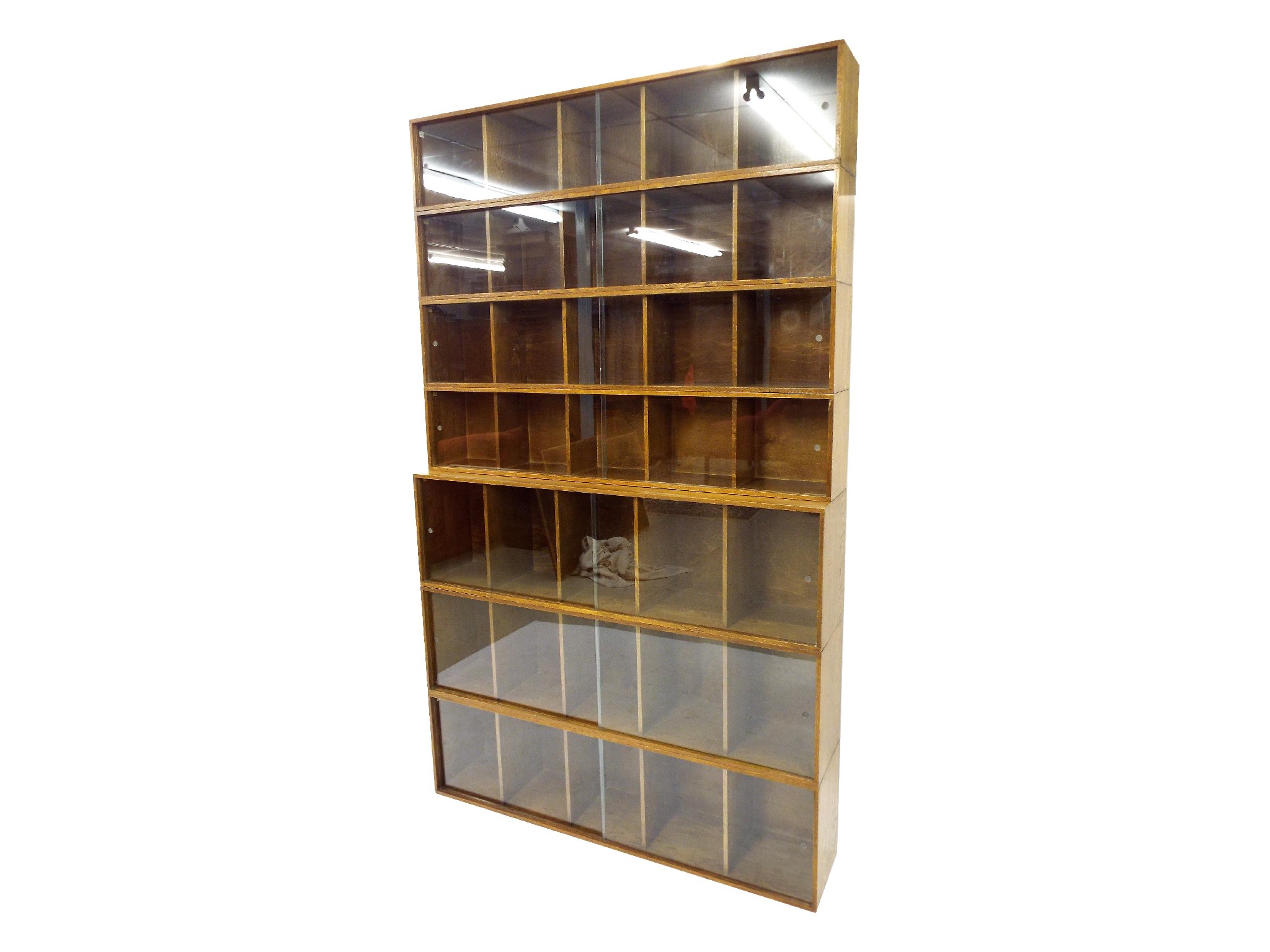 Appraisal: Mid th century 'Unix' golden oak modular bookcase comprising seven