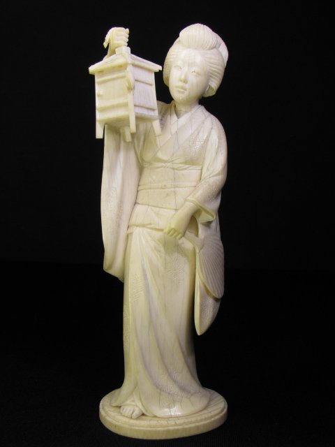 Appraisal: Carved th century ivory figurine of a Geisha holding a