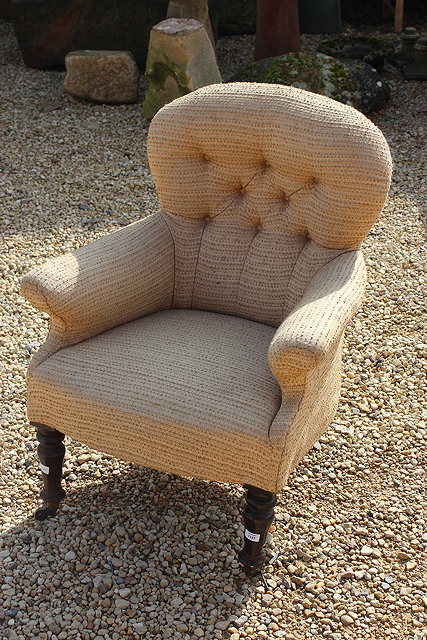 Appraisal: A VICTORIAN BUTTON UPHOLSTERED ARMCHAIR with shaped back scroll arms