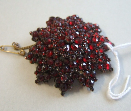 Appraisal: A Bohemian garnet set brooch in a starburst cluster design