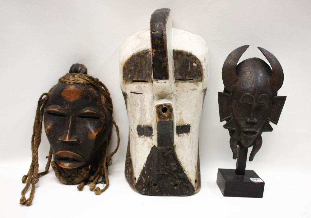 Appraisal: THREE AFRICAN TRIBAL MASKS bronze Senufo Kpelie mask Ivory Coast