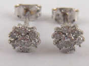 Appraisal: A pair of white metal tests carat gold diamond cluster