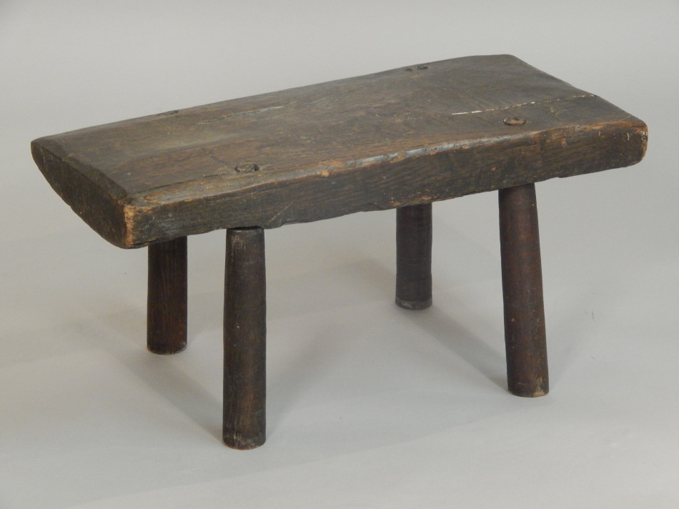 Appraisal: A rustic oak small bench or seat on cylindrical legs