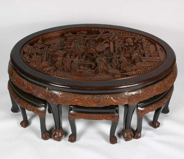 Appraisal: Intricately carved Asian tea table and six stools oval form