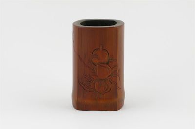 Appraisal: A Chinese bamboo brushpot carved with two peaches a pomegranate