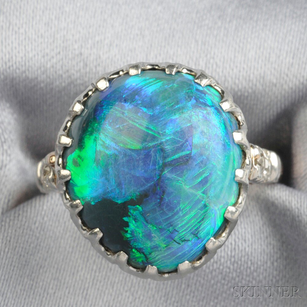 Appraisal: Opal and Diamond Ring prong-set with a drop-shape cabochon measuring